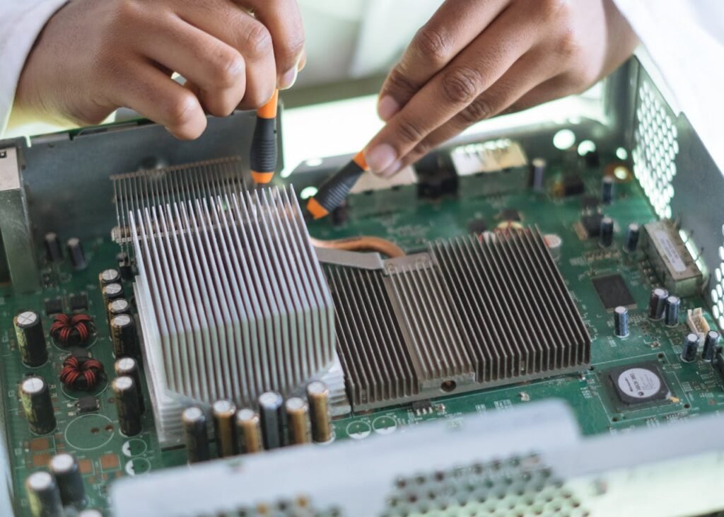 zipwp-image-3825581 Crop technician checking contacts on motherboard in workshop